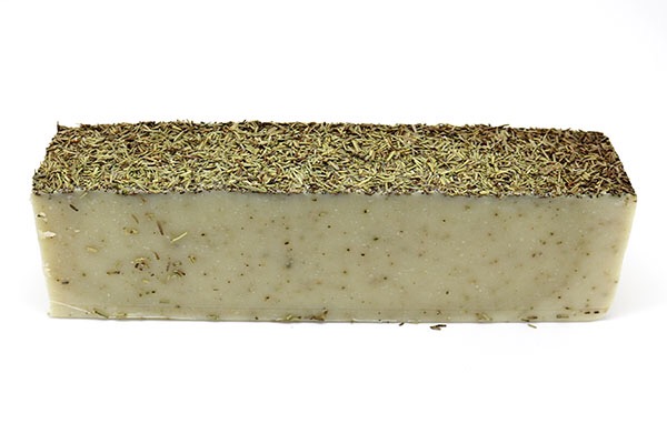 A gray soap, with a gray textured top, on a white background.