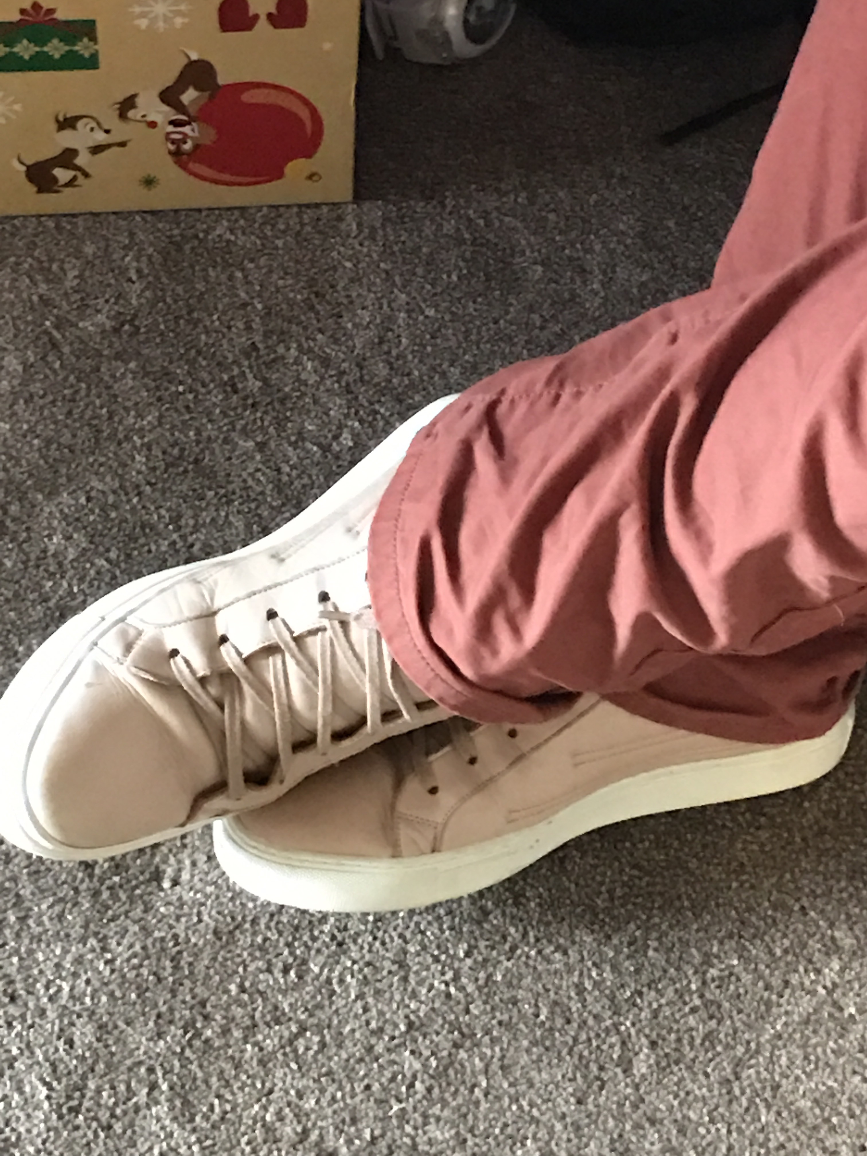 Some pale pink boots with white soles and white laces.