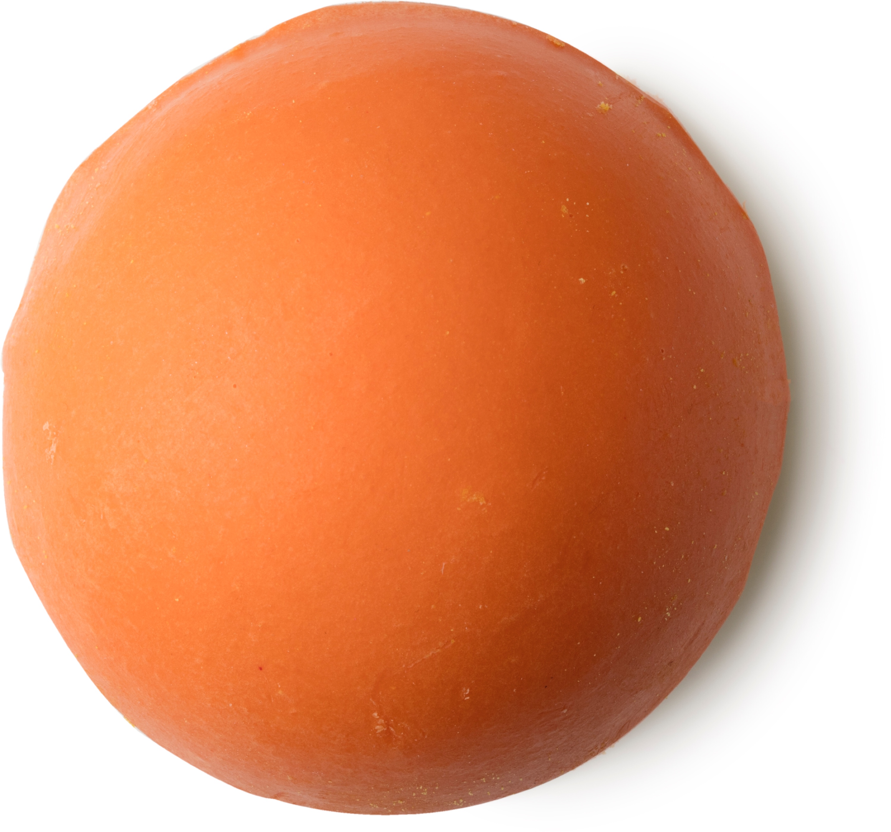 A bright orange circular bath bomb, on a white background