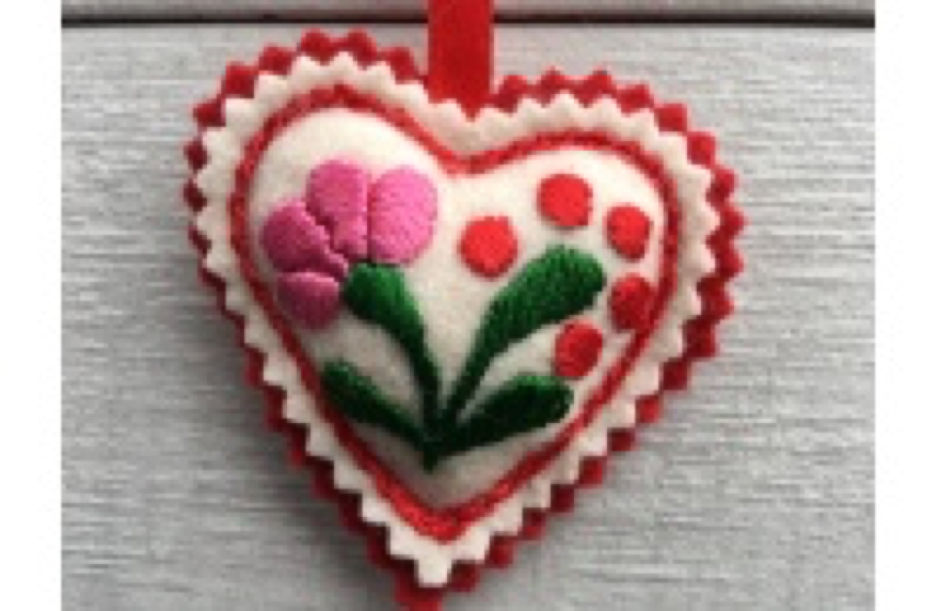 A white heart with some red trim around it, and a pink rose with green detailing, on a white background.