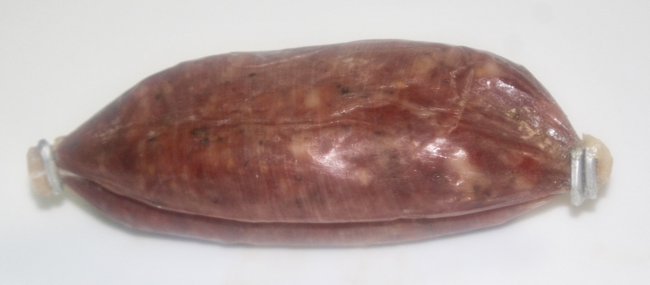 A dark red oval piece of meat with white marbling in the middle of it in some plastic, on a white background.