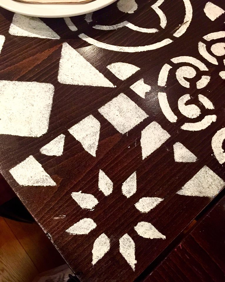 A black table with a white coloured pattern all over it.