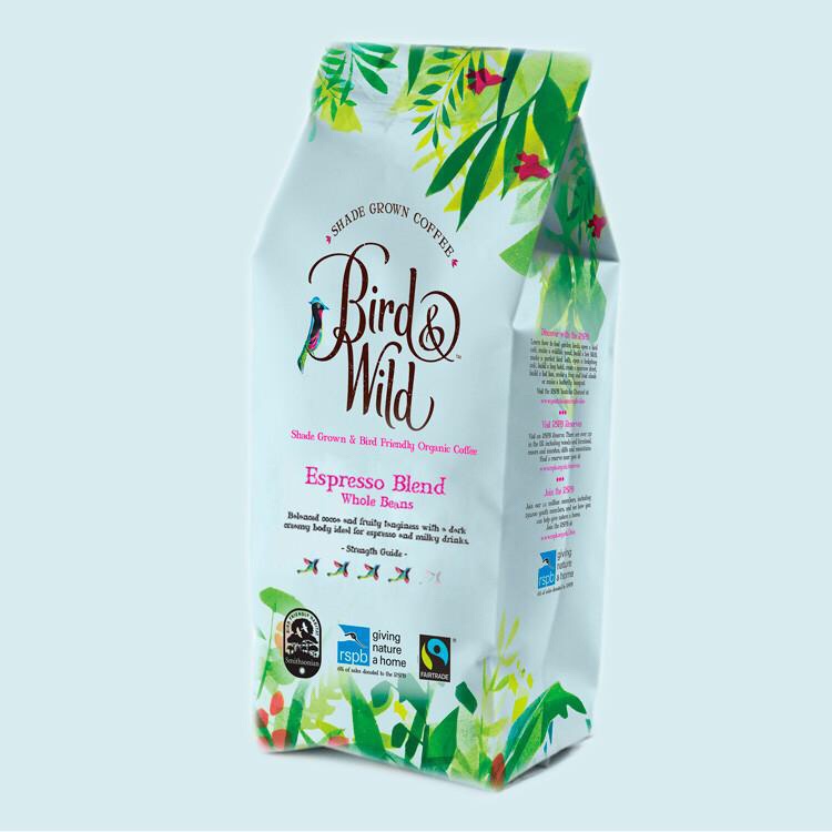 A large white rectangular packet that has a floral pattern around the edges, Bird & Wild written in cursive black writing and espresso blend written in smaller gold writing on it, on a white background.
