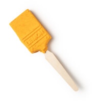 A bright Yellow rectangular paint brush shaped bubble bar with a light wooden handle, on a white background.