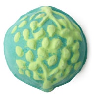 A large circular dark green bath bomb with some silver lustre and a star engraved on the top of it, on a white background.