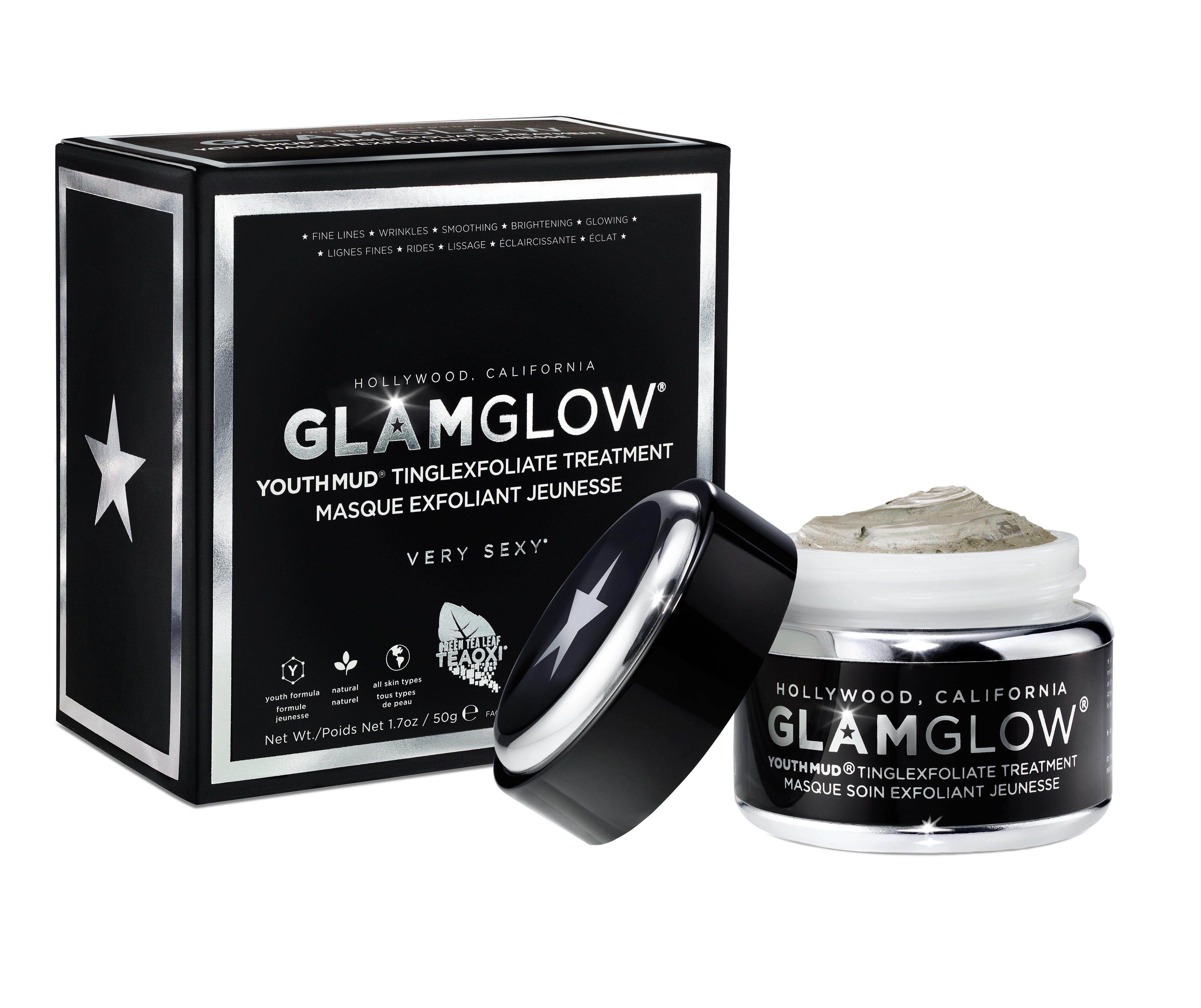 A short cylindrical black glass jar with a black lid that has GlamGlow YouthMud® Tinglexfoliate Treatment written in bold silver writing and a picture of a silver star on it next to a small rectangular black and silver box that has GlamGlow YouthMud® Tinglexfoliate Treatment written in bold silver writing and a picture of a silver star on it, on a white background.
