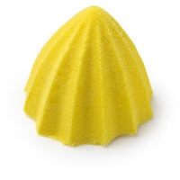 A bright yellow cone shaped shower bomb that has some vertical grooves all over it, on a white background.