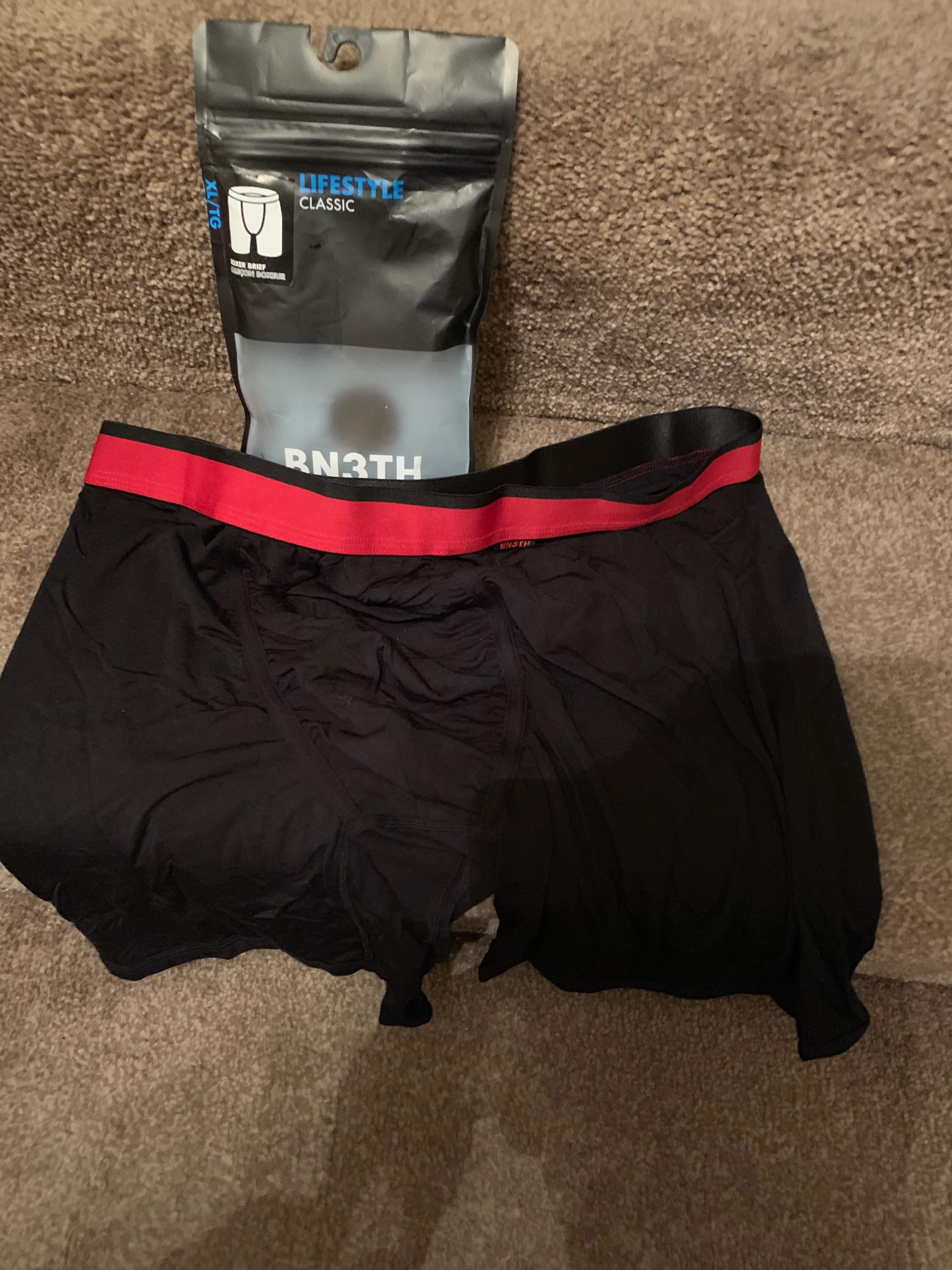 A pair of black and red boxer briefs on a white background.