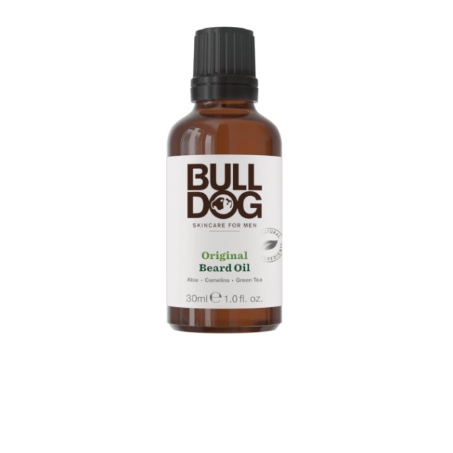 A short cylindrical brown glass bottle with a black lid that has Bulldog Skincare written in bold black writing and Original Beard Oil written in bright green writing on it, on a white background.