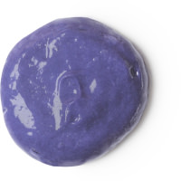 A circular puddle of dark purple conditioner, on a white background.