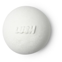  A large spherical shaped white Bath Bomb that has Lush written in white writing on it, on a white background.