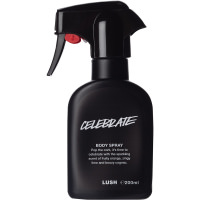 A tall black plastic kitchen spray bottle with a black label that has Lush Celebrate Body Spray written in bold white writing on it, on a white background.