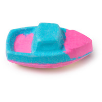 A large bright blue and pink boat shaped bath bomb, on a white background.