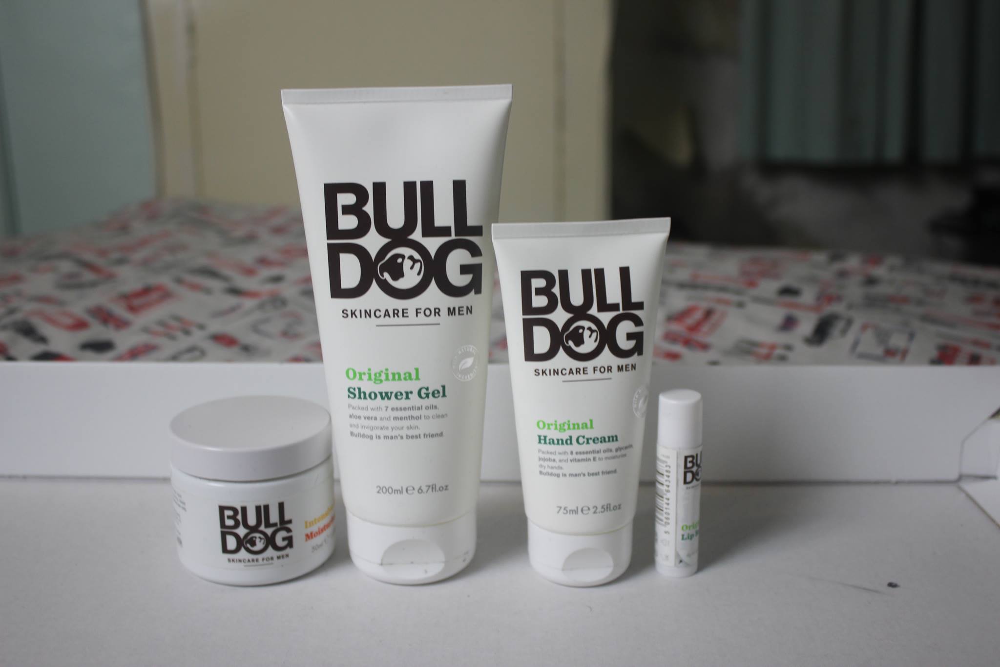 It's Bark Is Better Than It's Bite | Bulldog Skincare A picture of a cone shaped shower gel bottle, a cone shaped hand cream bottle, a small twist up lip balm tube, and a glass moisturiser tub.