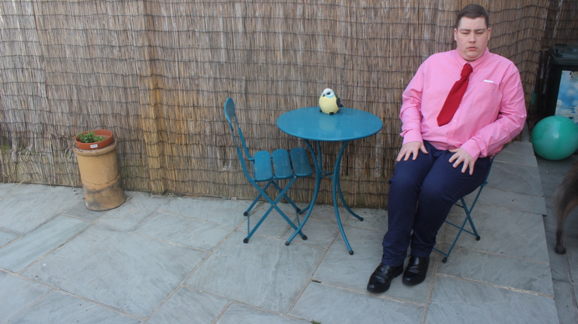 Me sat on a garden chair.