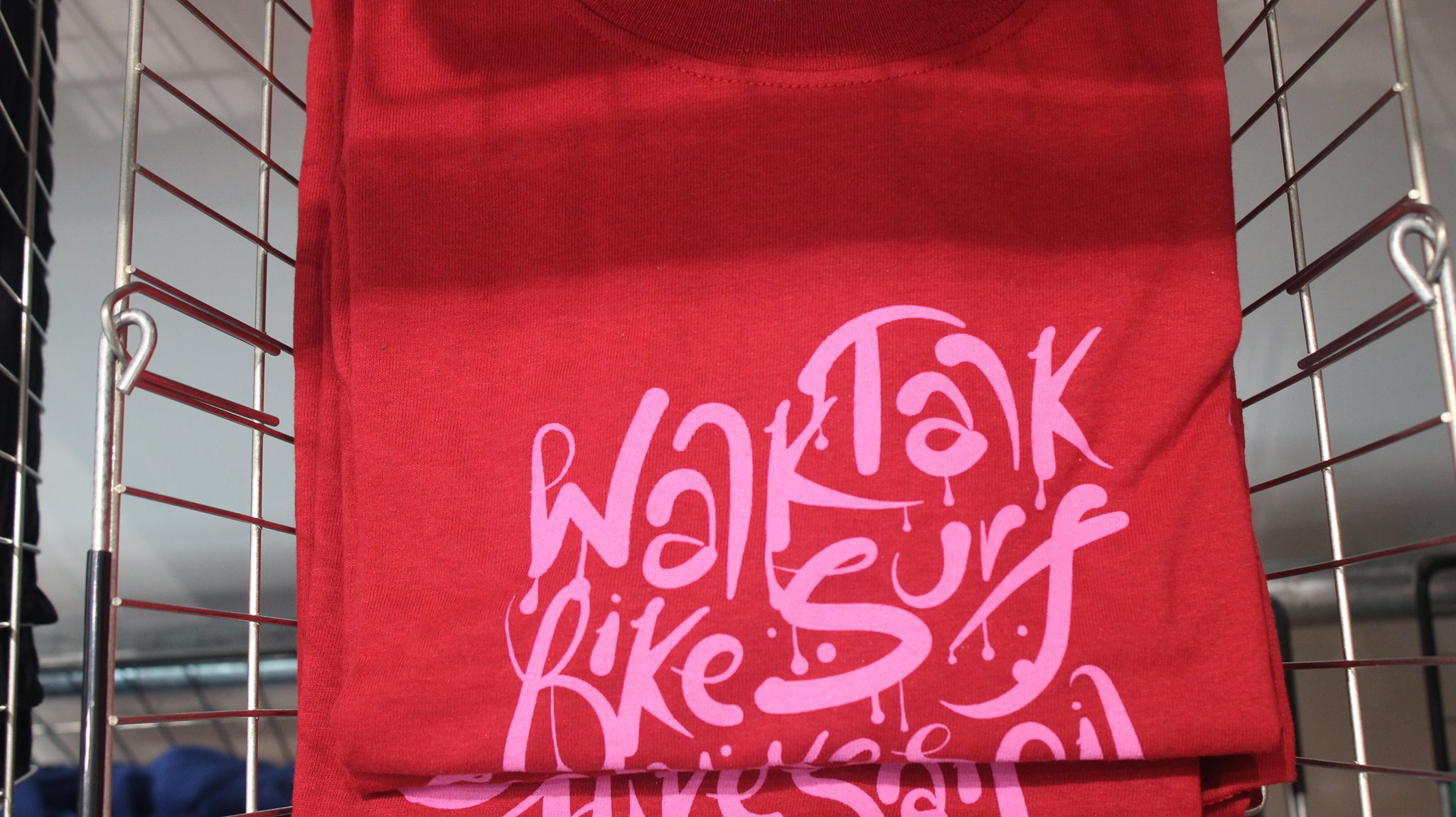 A pink t-shirt.with a pattern all over it.