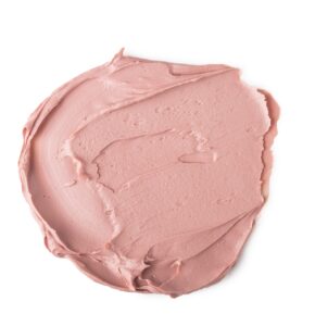 A circular puddle of some bright Pink face mask, on a white background.