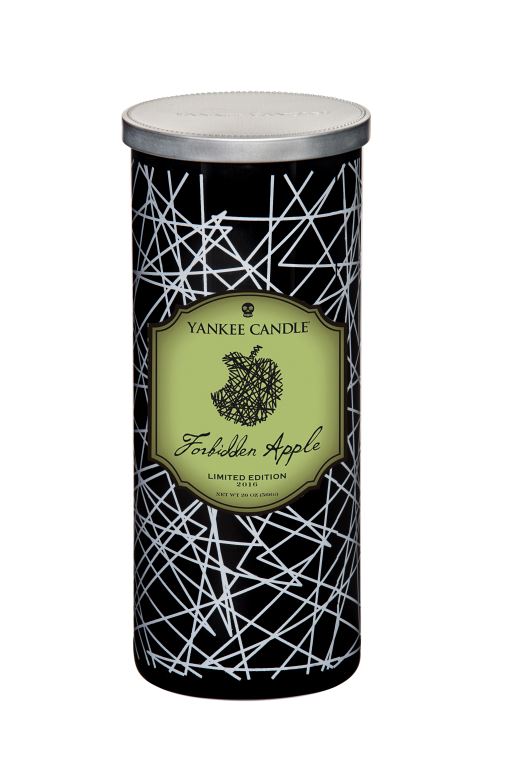 A black candle, with a green label and black text, on a white background.