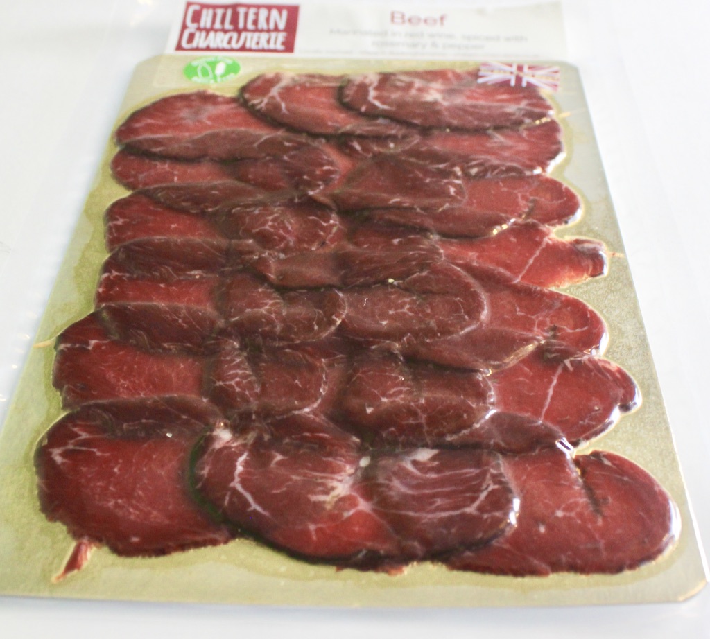#BlindGuyAdventures | Afternoon Tea, Facial Hair, and so much Wine. A rectangular see through packet with a red, white and blue Union Jack flag stuck on top containing Dark red Beef slices with a silver label containing a red logo saying Chiltern Charcuterie and Beef with a description in black writing on a white background