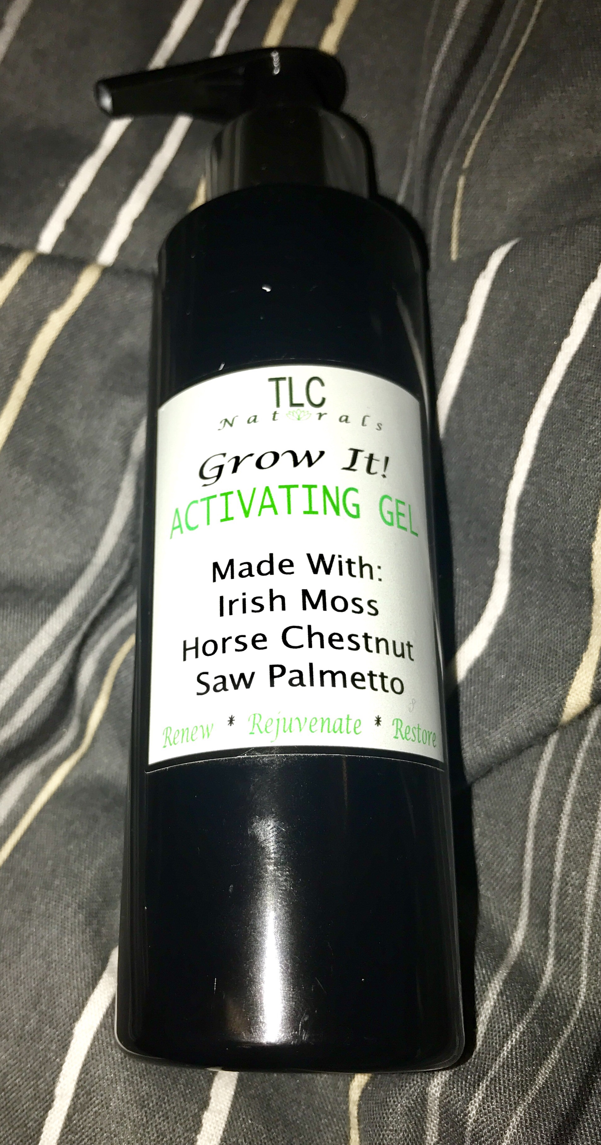 Naturally Thicker Hair | TLC Naturals Grow It! Activating Hair Growth Gel A black tall plastic bottle with a push down pump, with a white label that says TLC Naturals on it, on a stripy background.