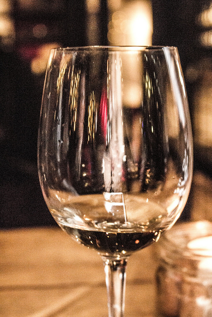 Sweet, Sugar, Candy Man! | Smith & Sinclair Leeds Pop Up Store Launch with The Alchemist Trinity Leeds A close up shot of a tall clear wine glass containing some White Wine and a few bubbles, on a light background.