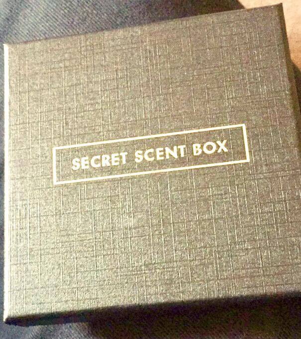 Shine The Spotlight | March 2017 A black Square box lid with secret sent box written in white bold capital letters with a white rectangular outline, on a black background