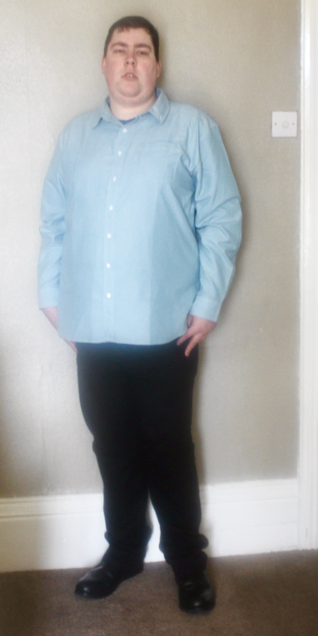 Outfit Of The Day | Looking Smart During Spring with Republic Union Me wearing a light green oxford shirt with an open collar, a pair of black trousers, and a pair of black boots, on a light beige background.