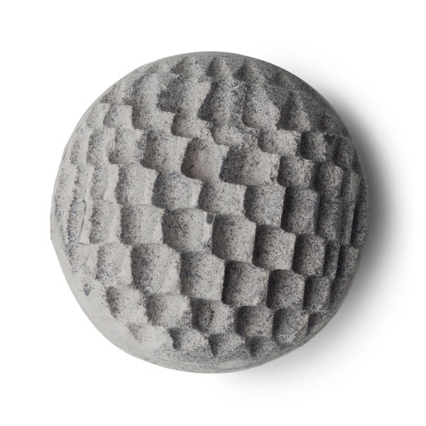 A silver spherical shaped blue tinted bath bomb with an intricate design all over it, on a white background.