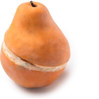 The Warmest Christmas Sweater Around | Lush Christmas 2017 Range A golden orange pear shaped soap with a dark brown stem and a cut In the middle of it that's filled with some bright white Cocoa Butter cream, on a white background.