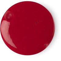 A circular pool of thick bright crimson red shower cream, on a white background.