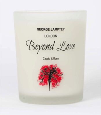 The Smell Of The Spoken Word | George Lamptey London Candles A tall white box that has George Lamptey London written in black writing, Beyond Love written in cursive pink writing, Rose and Cassis written in smaller Black writing and a picture of a small brown Cassis tree on it, on a white background.
