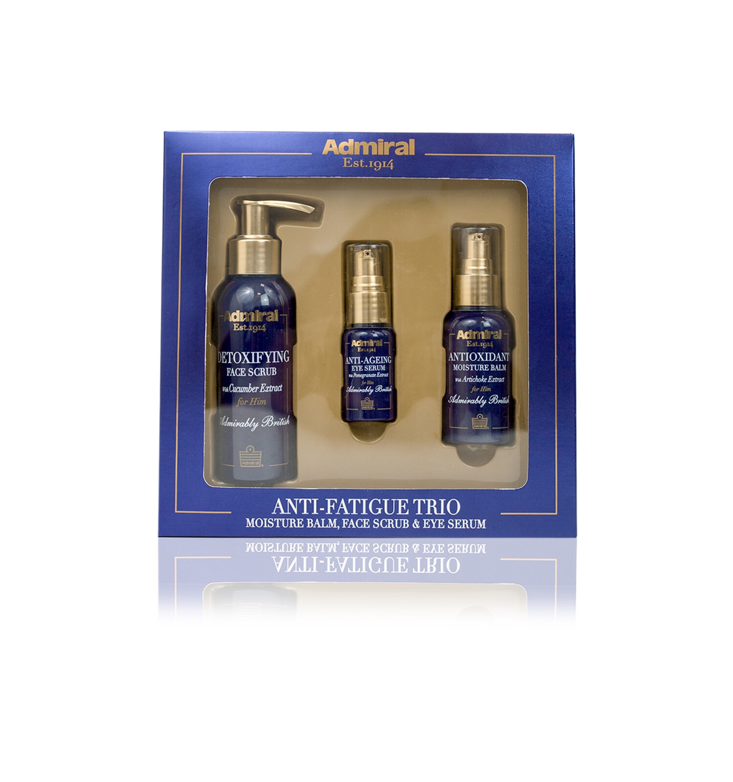 Three different sized cylindrical black bottles with gold lids and pumps sat on a light brown cardboard tray inside a rectangular blue box that has admiral grooming Anti-Fatigue Trio written in bold gold writing, antioxidant moisture balm, detoxifying facial scrub, and anti-ageing eye serum written in smaller gold writing on it, on a white background.