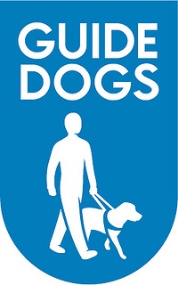 An elongated Sky Blue semi-circle that has a drawing of a white man, a white dog wearing a blue harness, and Guide Dogs written in capital bold white writing inside it, on a white background.