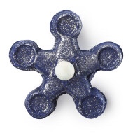 #BlindGuyAdventures | Anastacia, Lush, The Addams Family, and much more. A deep blue flower shaped bubble bar that has gold glitter on it on a white background.