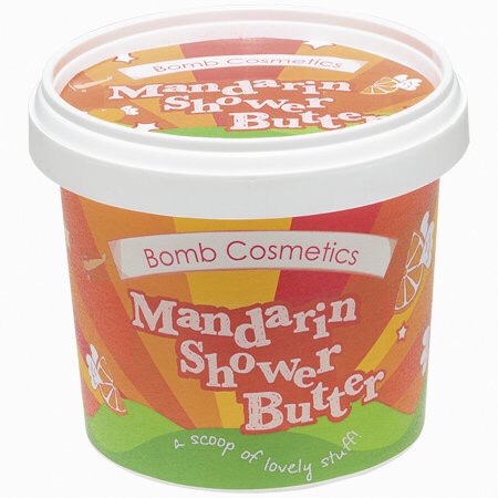 A short cylindrical Orange and Yellow plastic tub that has Bomb Cosmetics Mandarin Cleansing Shower Butter written in white writing on it, on a white background.