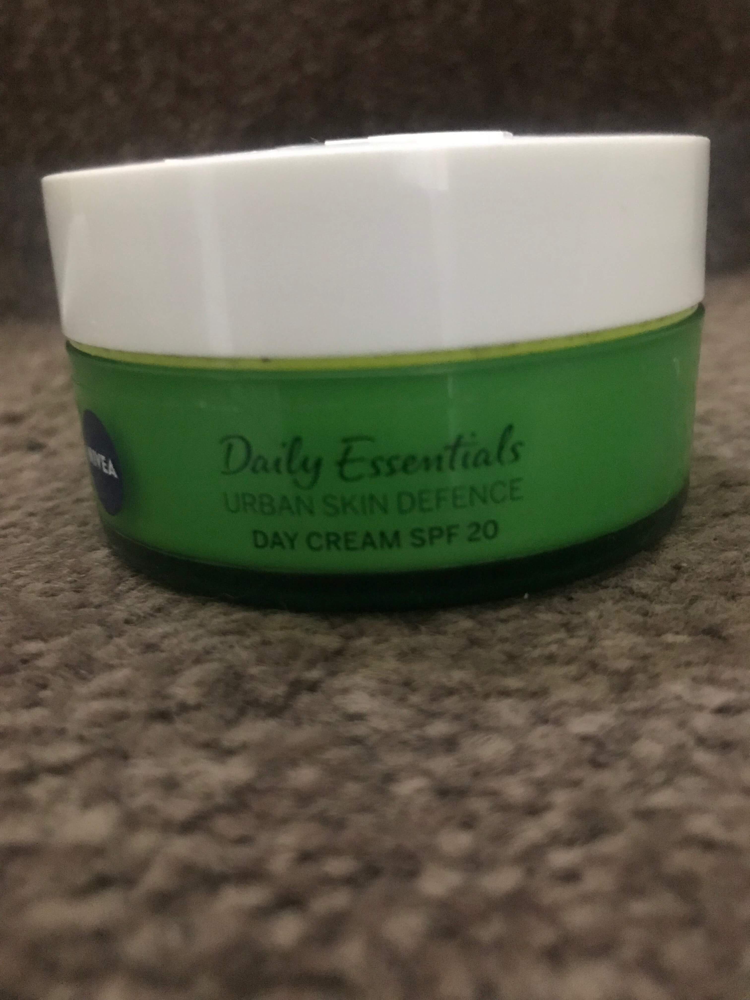 Defending My Skin Against Pollution | Nivea Urban Skin Defence Range A short cylindrical deep Green plastic tub with a white lid that has Nivea Urban Skin Defence Day Cream with SPF 20 written in blue writing on it, on a white background.