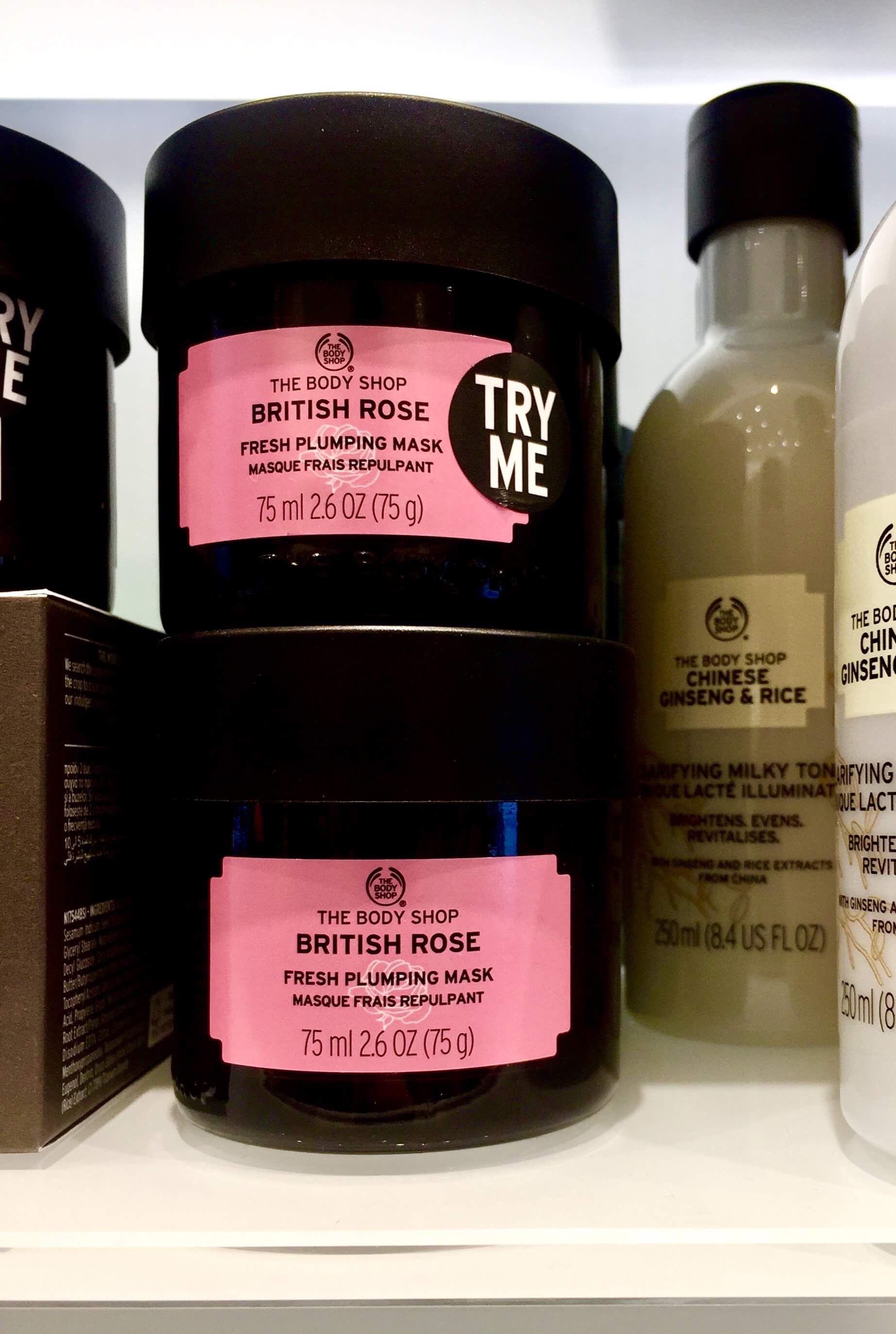 Off With Their Heads | The Body Shop British Rose Fresh Plumping Mask A short cylindrical black plastic tub with a black lid and a pink label that has The Body Shop British Rose Fresh Plumping Mask written in bold black writing on it, on a white background.
