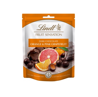 A rectangular white and orange plastic pouch that has Lindt Fruit Sensation written in cursive gold writing, Orange & Pink Grapefruit written in bold white writing, and a picture of some large oranges and some Pink grapefruits on it, on a white background.