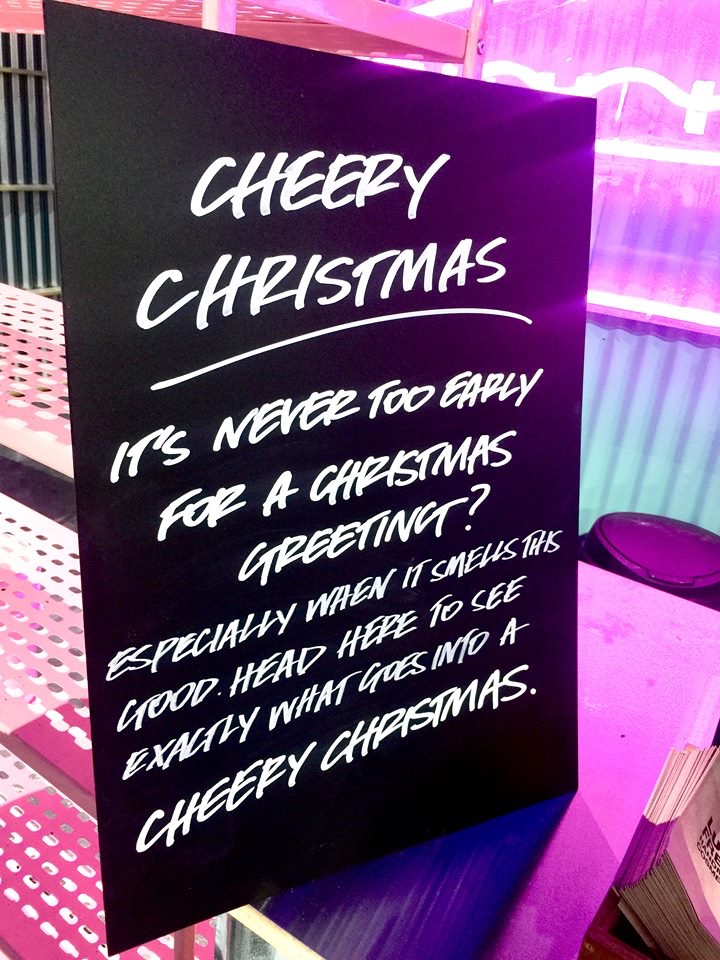 Rudolph Won't You Guide My Sleigh Tonight? | Lush Christmas 2018 Range A large black board that has Cheery Christmas written in bold white writing on it, on a white background.