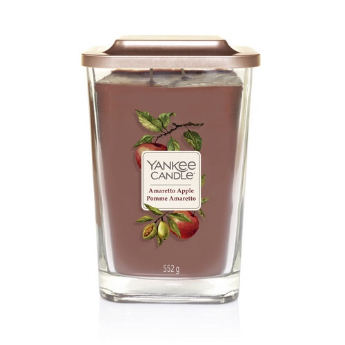 Lifting The Lid On Great Scent | Yankee Candle Elevation Collection A tall rectangular clear glass jar with a square gold lid full of some purple wax with a label that has Yankee Candle Amaretto Apple written in bold black writing and a picture of some green apples on it, on a white background.