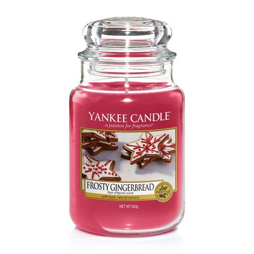 Sparkle Sparkle!| Yankee Candle Holiday Sparkle Collection A tall cylindrical Glass Jar full of some Pink coloured wax with a label that has Yankee Candle written in black writing, Frosty Gingerbread written in black writing, and a picture of some star shaped iced Gingerbread on it, on a white background.
