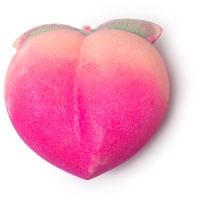 A large bright pink Peach shaped Bath Bomb that has some Gold Lustre on it, on a white background.