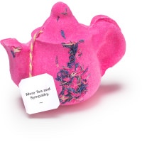 a large bright pink teapot shaped bath bomb that has some Blue Cornflower Petals embedded on it, on a white background.