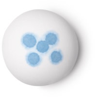 A large spherical shaped white bath bomb that has some deep blue spots on top of it, on a white background.