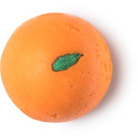 A large semi circular block of bright orange soap that has a leaf engraved on the top of it, on a white background.