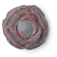 Our Anniversary Went Off Without A Bang! | Lush 30th Anniversary Bath Bombs A large black rose shaped bath bomb that has a bright pink centre, on a white background.