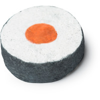 A large circular shaped white bath bomb that has a Black outline and a piece of bright red plasticine in the middle of it, on a white background.