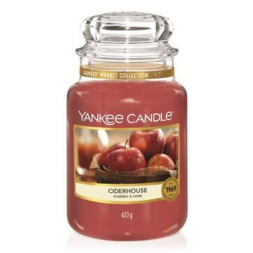 I'm Taking The Cow To Market | Yankee Candle Farmer's Market Collection A tall glass jar full of some bright red wax with a label that has Yankee Candle written in white writing, Ciderhouse written in black writing , and some pictures of some Apples on it, on a white background.