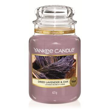 What I Thought of the Yankee Candle Advent House 2014 A tall glass jar full of some bright lilac wax with a label that has Yankee Candle written in white writing, Dried Lavender & Oak written in black writing , and some pictures of some sprigs of Lavender on it, on a white background.