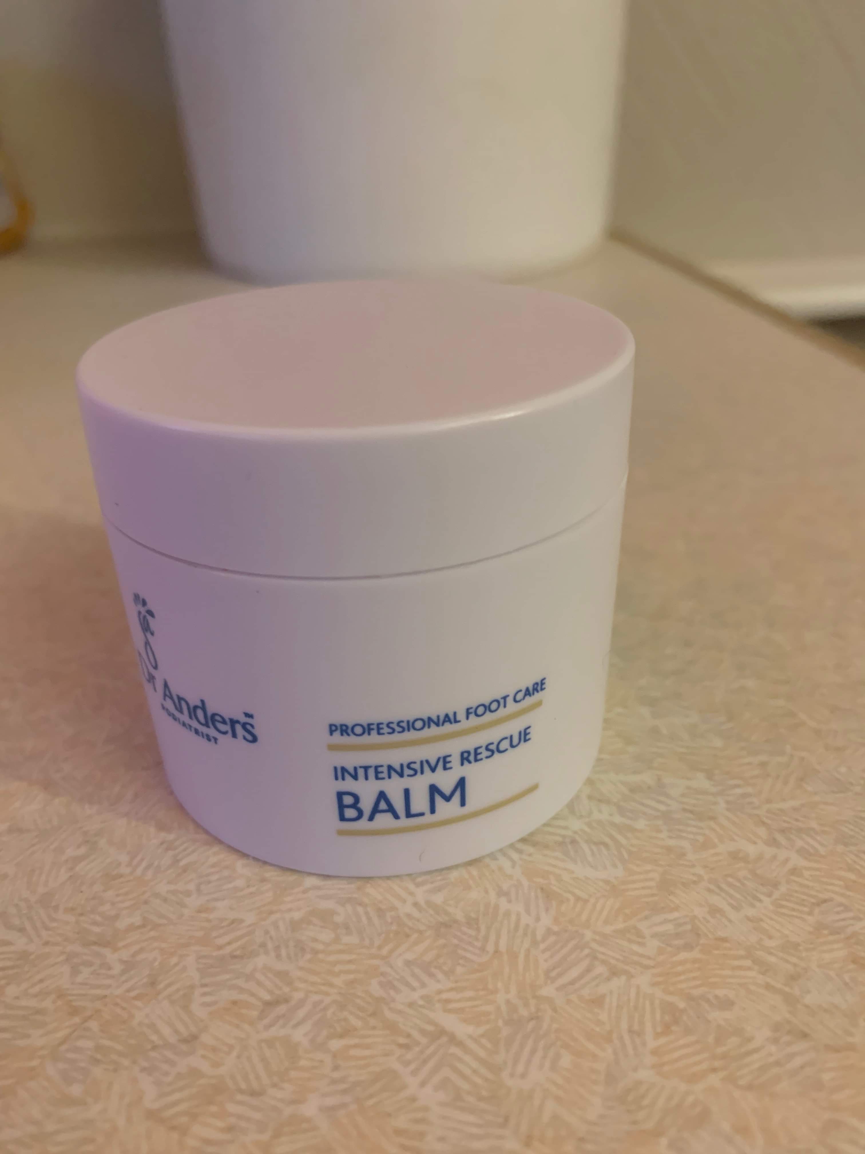 You've Got Chocolate All Around Your Mouth | Superdrug Skin Rescue Chocolate Orange Self-Heating Mask A short cylindrical white plastic tub with a white plastic lid that has Dr Anders intensive rescue balm written in bold blue writing on it, on a white background.